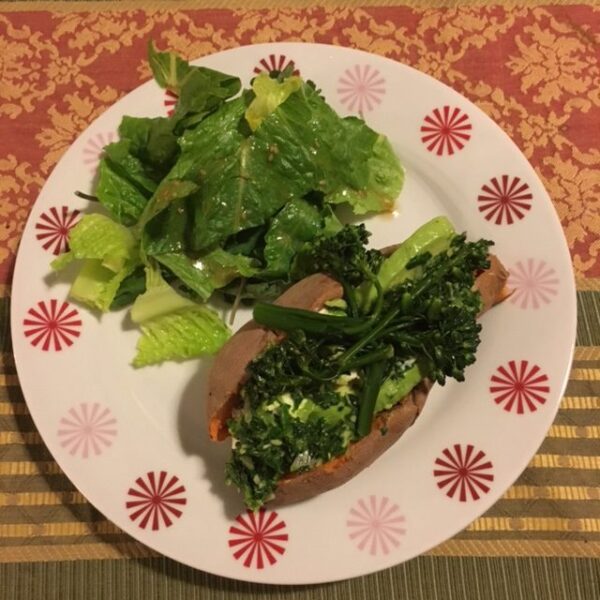 stuffed sweet potato on plate with salad
